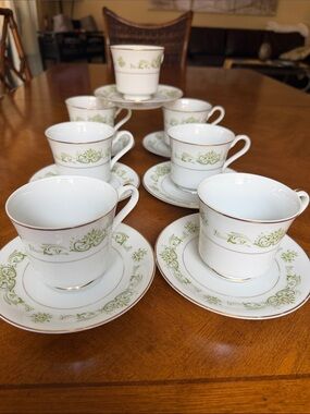 White Porcelain Tea Cup and Saucer Set with Green Scroll Accent